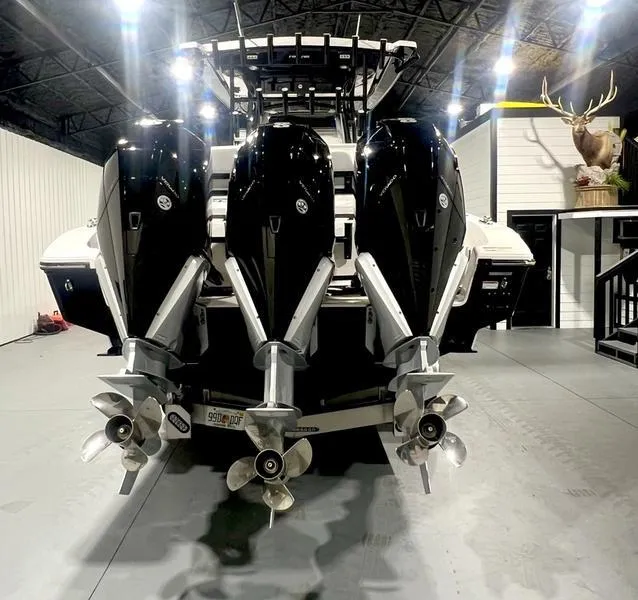 Slide: The Image of 2022 Fountain 34 TE boat with triple outboard engines in a showroom. - 5