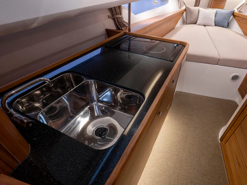 Slide: The Image of 2024 Nimbus C11 interior with sleek kitchen sink and cozy cabin bed. - 11