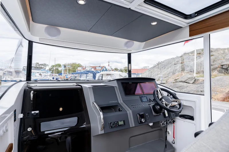 Slide: The Image of Interior view of 2024 Nimbus C11 boat cockpit with modern controls and steering wheel. - 6