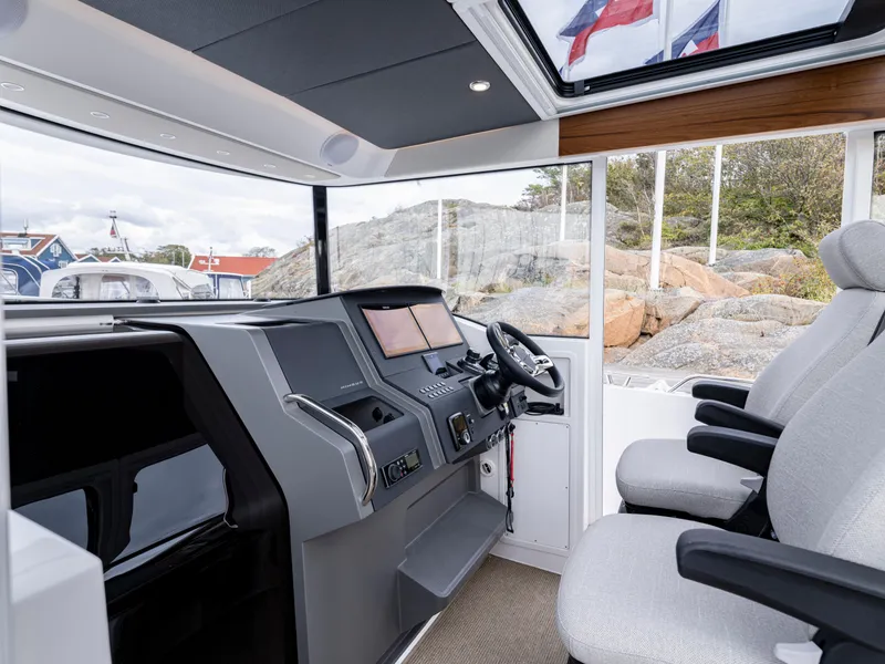 Slide: The Image of 2024 Nimbus C11 boat interior with modern dashboard and comfortable seating. - 7