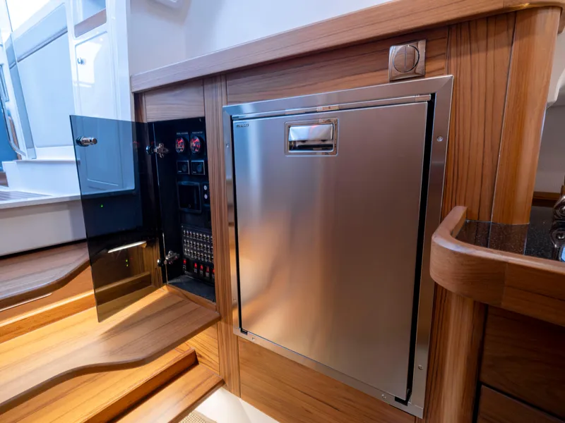 Slide: The Image of 2024 Nimbus C11 interior with stainless steel panel and control system, featuring wooden accents. - 9