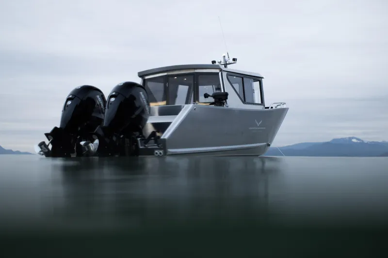Slide: The Image of 2025 Jasper Marine Defender 22 boat with dual outboard motors on calm water. - 4