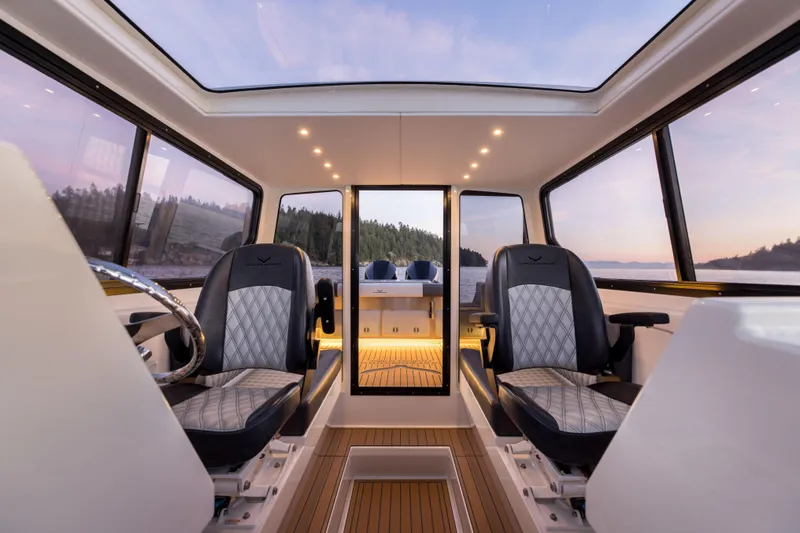 Slide: The Image of Interior of 2025 Jasper Marine Defender 22 boat with panoramic windows and luxury seating. - 43
