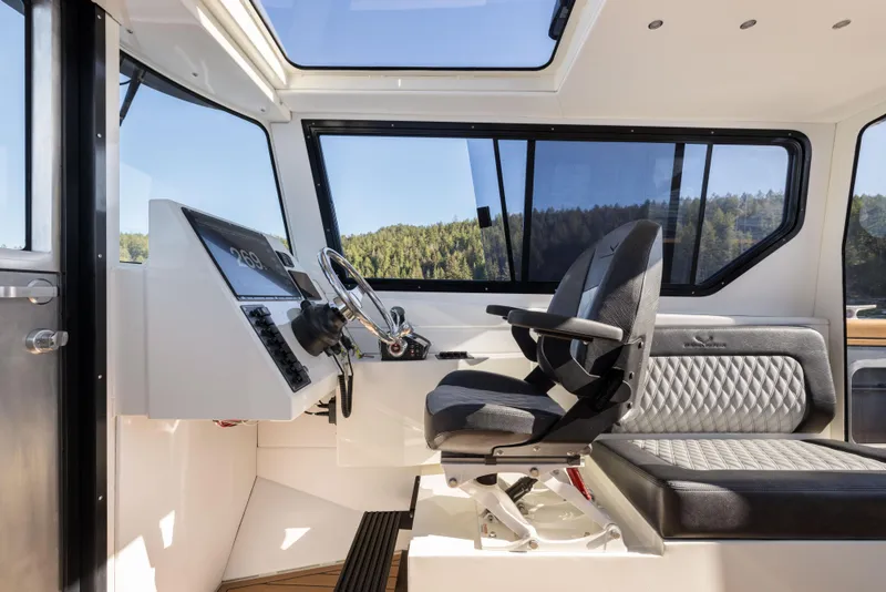 Slide: The Image of Interior of 2025 Jasper Marine Defender 22 boat, featuring modern helm and seating. - 48