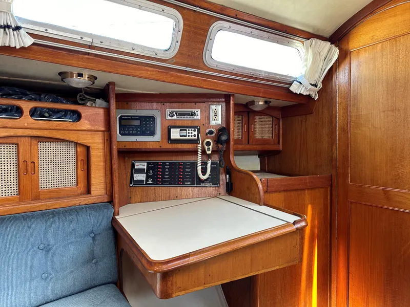 Slide: The Image of 1988 Ericson 34 sailboat interior with navigation station and wooden cabinetry. - 11