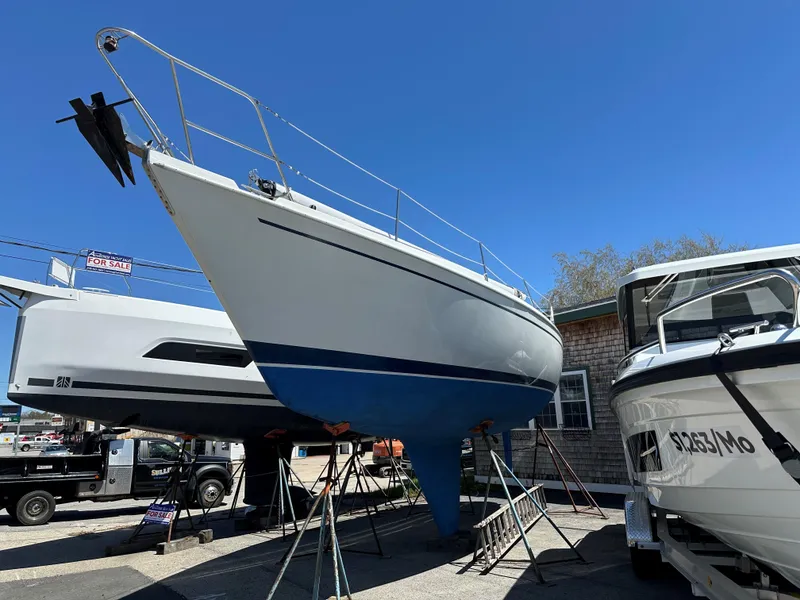 Slide: The Image of 1988 Ericson 34 sailboat on stands in a boatyard, clear blue sky. - 7