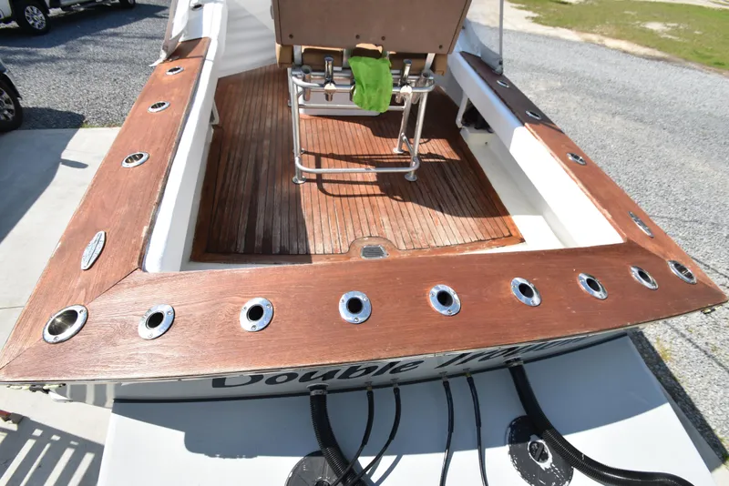 Slide: The Image of Custom Carolina 28 Cape Lookout boat deck, 2007 model, repowered in 2019, featuring wooden finish. - 19