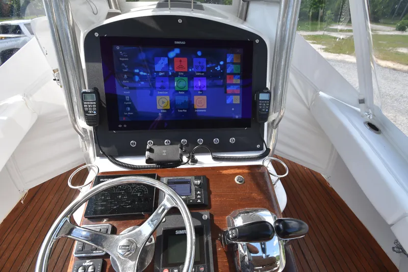 Slide: The Image of Helm of 2007 Custom Carolina 28 Cape Lookout with modern navigation system. - 29
