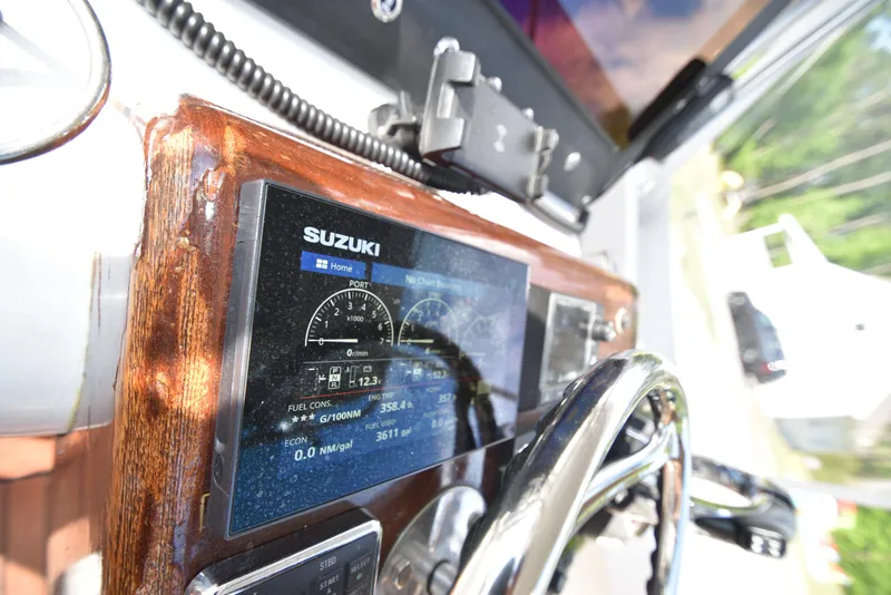 Slide: The Image of Close-up of a 2007 Custom Carolina 28 Cape Lookout boat dashboard with Suzuki display. - 35