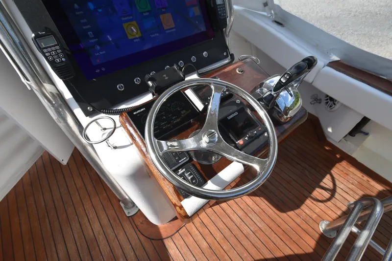 Slide: The Image of Helm of 2007 Custom Carolina 28 Cape Lookout, featuring modern controls and wood finish. - 36