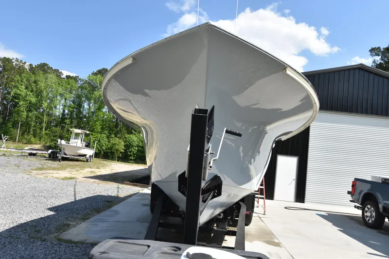Slide: The Image of Custom Carolina 28 Cape Lookout boat, 2007 model, repowered in 2019, on trailer outdoors. - 4