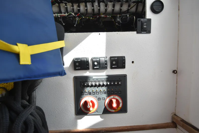 Slide: The Image of Control panel of a 2007 Custom Carolina 28 Cape Lookout boat, featuring switches and wiring. - 44