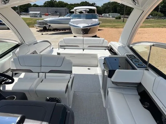 Slide: The Image of 2025 Formula 330 Crossover Bowrider I/O interior with white seating and modern design. - 12