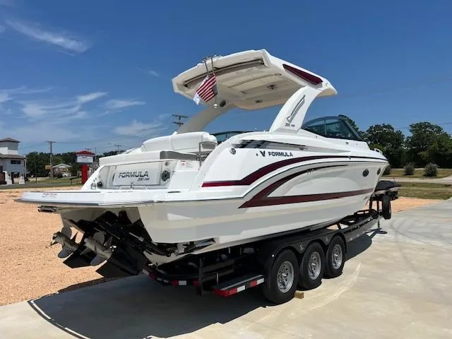 Slide: The Image of 2025 Formula 330 Crossover Bowrider I/O on a trailer, rear view. - 2