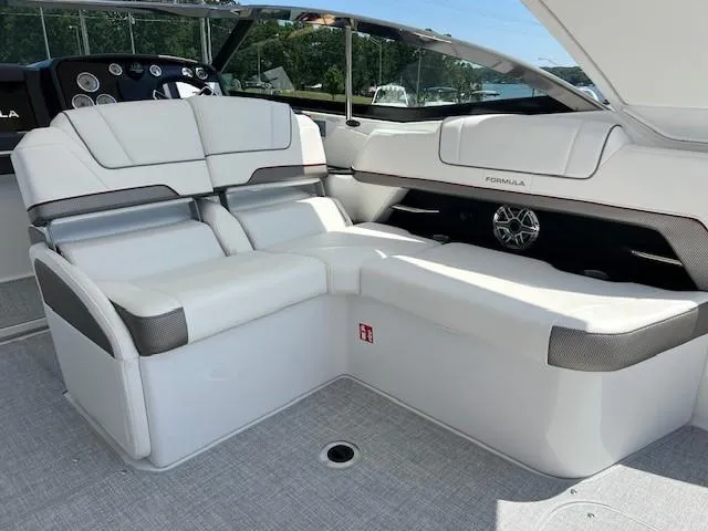 Slide: The Image of 2025 Formula 330 Crossover Bowrider I/O interior with white seating and modern design. - 6