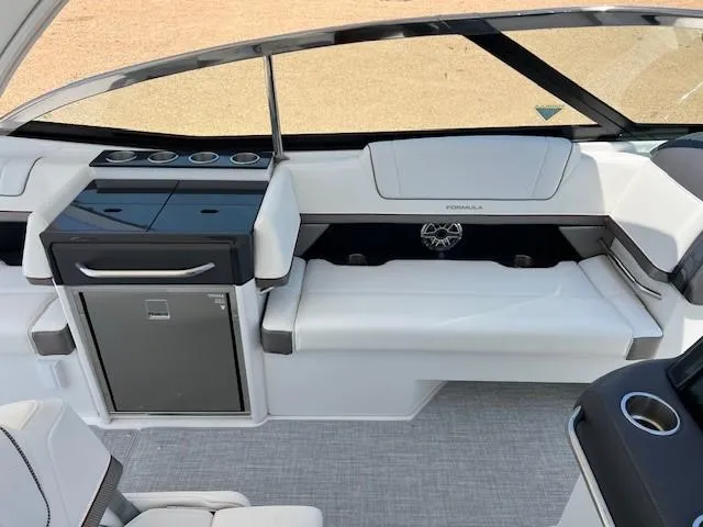 Slide: The Image of 2025 Formula 330 Crossover Bowrider I/O interior with seating and storage. - 7