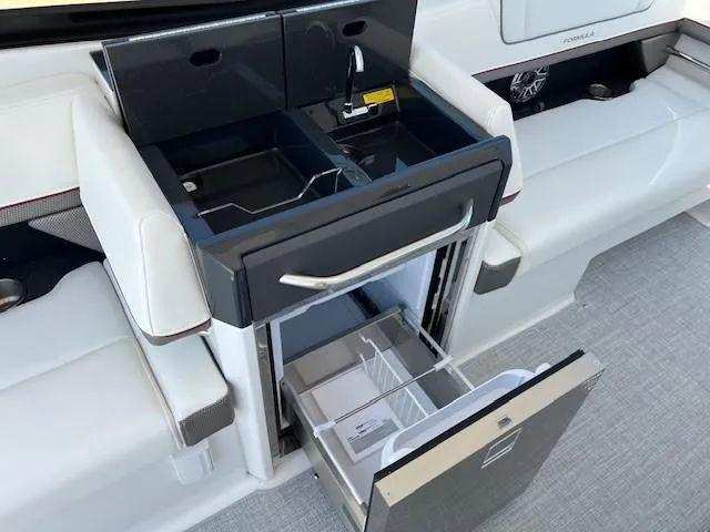 Slide: The Image of 2025 Formula 330 Crossover Bowrider I/O interior with mini kitchen and storage. - 8