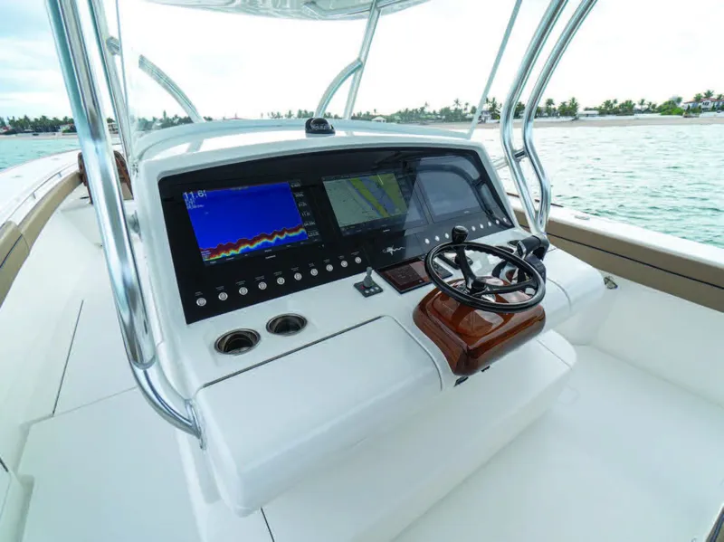 Slide: The Image of 2025 Valhalla Boatworks V-41 helm with advanced navigation system and steering wheel. - 13