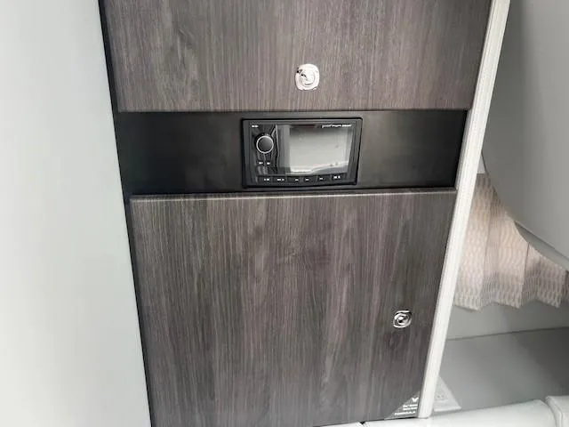 Slide: The Image of 2025 Formula 350 Crossover Bowrider I/O interior control panel and storage compartment. - 15