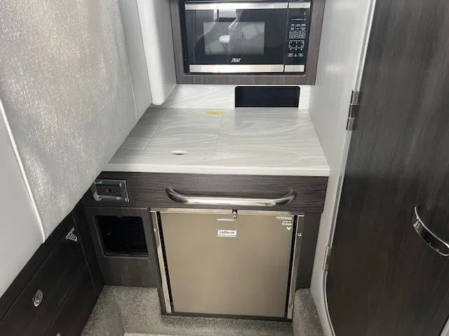 Slide: The Image of 2025 Formula 350 Crossover Bowrider I/O interior kitchenette with microwave and mini-fridge. - 17