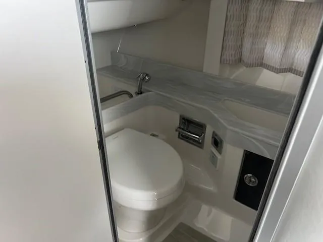 Slide: The Image of 2025 Formula 350 Crossover Bowrider I/O bathroom with modern fixtures and sleek design. - 18