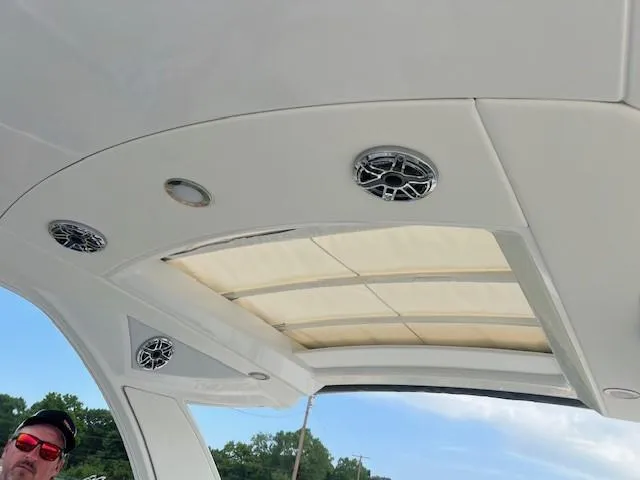 Slide: The Image of 2025 Formula 350 Crossover Bowrider I/O boat interior with speakers and sunroof. - 19
