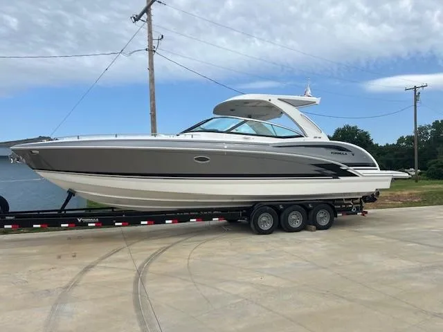 Slide: The Image of 2025 Formula 350 Crossover Bowrider I/O on trailer by the water. - 4