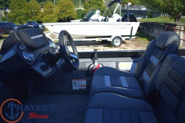 Slide: The Image of 2024 Ranger RT178 boat interior with steering console and seating, displayed at Thayer's Marine. - 13