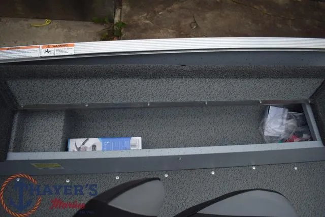 Slide: The Image of 2024 Lund 1600 Fury Tiller boat storage compartment with items inside. - 10