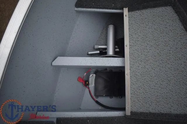Slide: The Image of 2024 Lund 1600 Fury Tiller boat interior with storage compartment and wiring. - 13