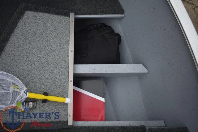 Slide: The Image of Storage compartment of 2024 Lund 1600 Fury Tiller boat with fishing gear and bag. - 14
