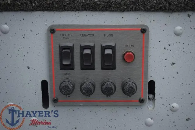 Slide: The Image of Control panel of 2024 Lund 1600 Fury Tiller boat with switches and dials. - 16