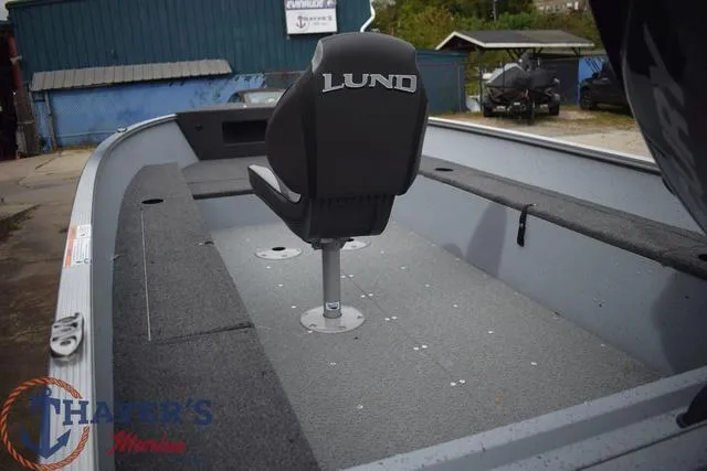 Slide: The Image of 2024 Lund 1600 Fury Tiller boat interior with single seat and Thayer's Marine logo. - 17