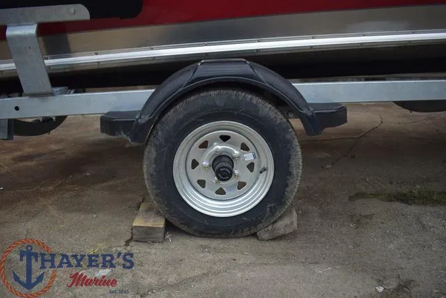 Slide: The Image of Trailer wheel of a 2024 Lund 1600 Fury Tiller boat at Thayer's Marine. - 7