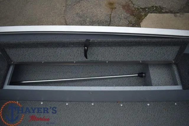 Slide: The Image of 2024 Lund 1600 Fury Tiller boat storage compartment with rod holder. - 9