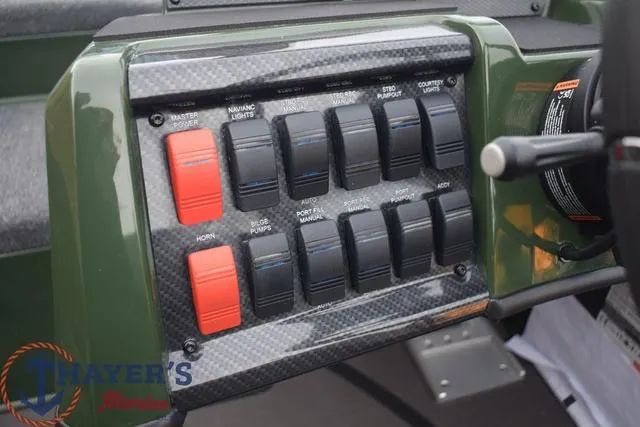Slide: The Image of Control panel of 2024 Triton 20XP boat with various switches and labels. - 10