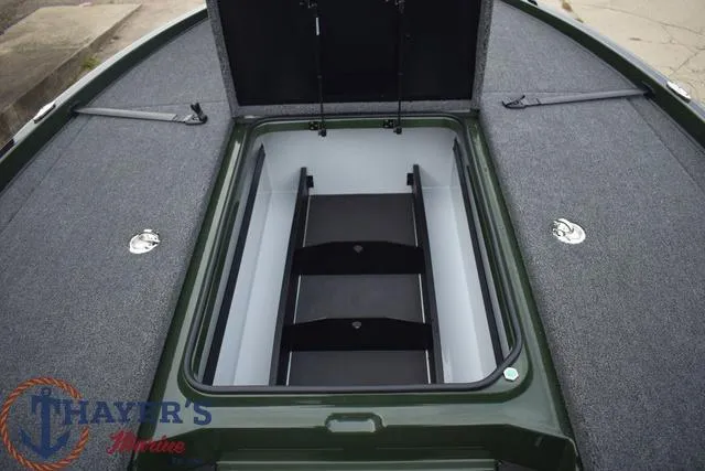 Slide: The Image of 2024 Triton 20XP boat storage compartment with open lid. - 16