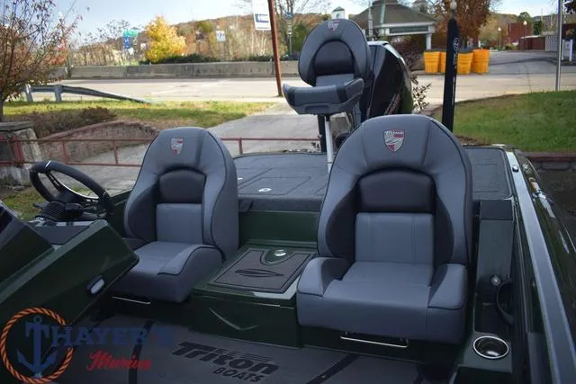 Slide: The Image of 2024 Triton 20XP boat interior with gray seats and steering wheel. - 18