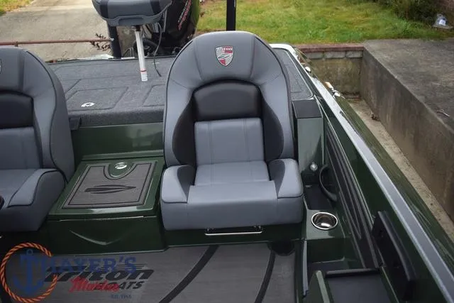 Slide: The Image of 2024 Triton 20XP boat interior with gray seats and logo. - 20