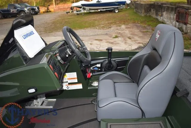 Slide: The Image of 2024 Triton 20XP boat interior with steering wheel and gray captain's chair. - 21