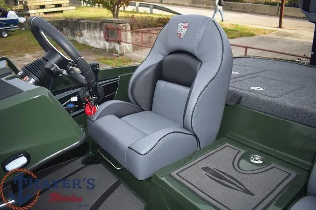 Slide: The Image of 2024 Triton 20XP boat interior with gray captain's seat and steering wheel. - 22