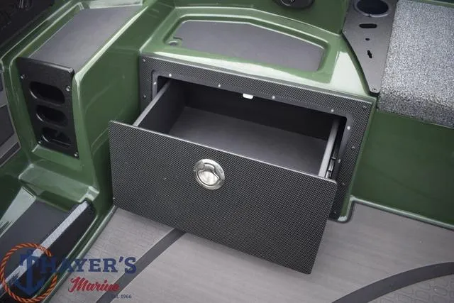 Slide: The Image of 2024 Triton 20XP boat storage compartment with open drawer. - 23