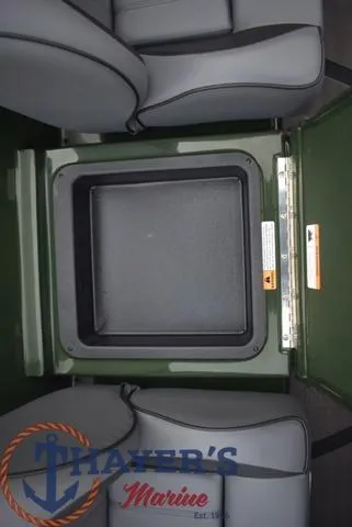 Slide: The Image of 2024 Triton 20XP boat interior storage compartment with gray seating. - 24