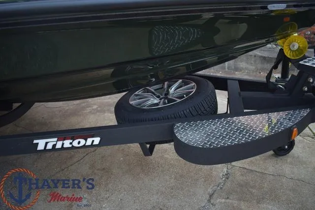 Slide: The Image of 2024 Triton 20XP boat trailer with spare tire and Thayer's Marine logo. - 6
