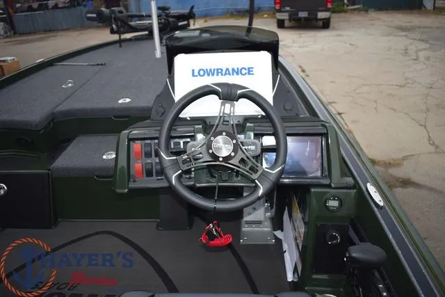 Slide: The Image of 2024 Triton 20XP boat dashboard with Lowrance electronics and steering wheel. - 9