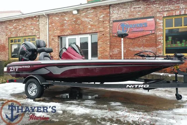 Slide: The Image of 2024 Nitro Z17 bass boat on trailer outside Thayer's Marine dealership. - 1