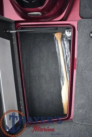 Slide: The Image of Storage compartment of a 2024 Nitro Z17 boat with a wooden paddle inside. - 13