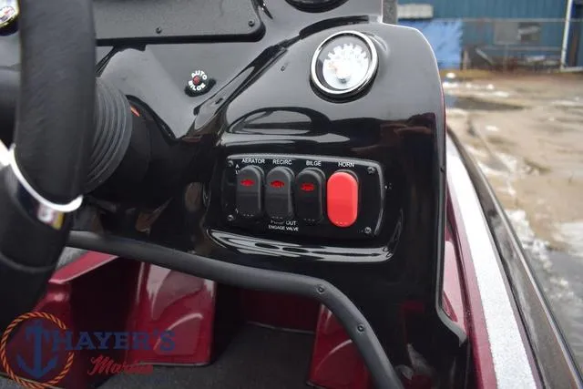 Slide: The Image of Control panel of a 2024 Nitro Z17 boat with various switches and gauges. - 16