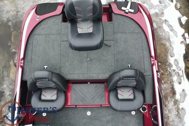 Slide: The Image of 2024 Nitro Z17 boat interior with three black and red seats, gray carpet, and snow around. - 8