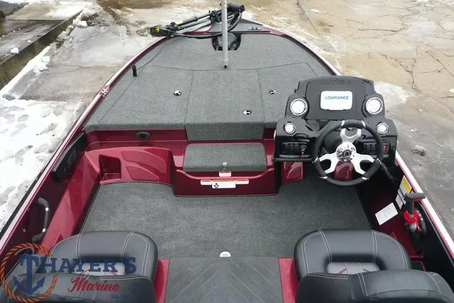 Slide: The Image of 2024 Nitro Z17 boat interior with steering console and seating, Thayer's Marine logo. - 9